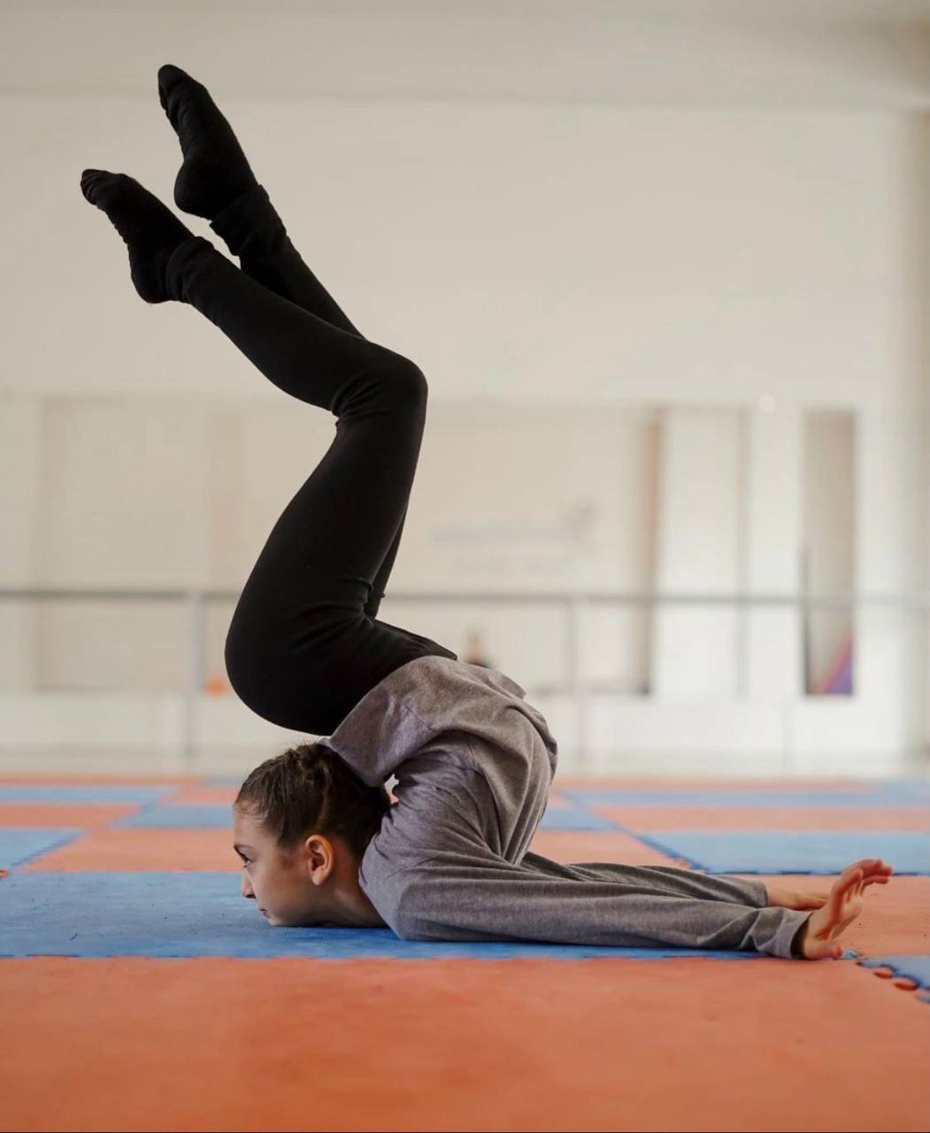 A child doing a gentle backbend stretch on the mat